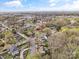 Expansive aerial view showcasing the neighborhood and surrounding area with blue sky, and a mix of houses and foliage at 311 3Rd Avenue Se Dr, Hickory, NC 28602