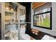 Chic bathroom with a glass-door cabinet, stylish decor, and a bright window with natural views at 311 3Rd Avenue Se Dr, Hickory, NC 28602