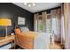 Stylish bedroom with dark walls, windows, and an orange patterned bedspread at 311 3Rd Avenue Se Dr, Hickory, NC 28602