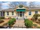 Welcoming front porch with seating, green awning and colorful landscaping at 311 3Rd Avenue Se Dr, Hickory, NC 28602