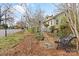 Charming yellow house with a quaint front yard, featuring a stone path, wrought-iron bench, and picket fence at 311 3Rd Avenue Se Dr, Hickory, NC 28602