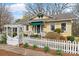 Charming yellow home with a white picket fence and well-manicured landscaping at 311 3Rd Avenue Se Dr, Hickory, NC 28602