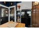 Cozy kitchen features a black refrigerator and vintage decor on shelves, creating a unique space at 311 3Rd Avenue Se Dr, Hickory, NC 28602