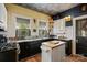 Charming kitchen featuring unique stainless counters, black cabinetry, and a stylish tin ceiling at 311 3Rd Avenue Se Dr, Hickory, NC 28602