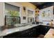 Well-lit kitchen with stainless counters, black cabinetry and vintage-style decor at 311 3Rd Avenue Se Dr, Hickory, NC 28602