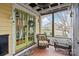 Inviting screened porch with cozy seating and a view of the front yard and neighborhood at 311 3Rd Avenue Se Dr, Hickory, NC 28602