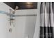 Clean shower with white tile, decorative blue trim, and an adjustable shower head at 311 3Rd Avenue Se Dr, Hickory, NC 28602
