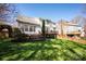 Expansive backyard featuring a deck, lush lawn, and mature trees at 3329 Brownes Creek Rd, Charlotte, NC 28269