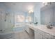Bathroom featuring a glass shower, soaking tub, and double sink vanity with white cabinets and countertops at 3329 Brownes Creek Rd, Charlotte, NC 28269