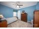 Inviting blue bedroom featuring classic wooden furniture, and a ceiling fan at 3329 Brownes Creek Rd, Charlotte, NC 28269