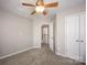 Neutral bedroom with an entry door a ceiling fan and a double-door closet at 3329 Brownes Creek Rd, Charlotte, NC 28269