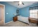 Cozy blue bedroom with a wooden bed frame and lamp at 3329 Brownes Creek Rd, Charlotte, NC 28269