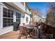 Back deck with metal chairs, table, barbecue grill, and a view of the trees and other houses at 3329 Brownes Creek Rd, Charlotte, NC 28269