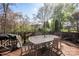 Outdoor patio with metal chairs and table surrounded by trees and greenery at 3329 Brownes Creek Rd, Charlotte, NC 28269