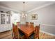 Elegant dining room featuring hardwood floors, a decorative chandelier, and a classic wooden dining table at 3329 Brownes Creek Rd, Charlotte, NC 28269