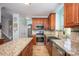 Bright kitchen boasts stainless appliances, granite counters, and wood floors at 3329 Brownes Creek Rd, Charlotte, NC 28269