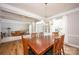 Open-concept living and dining area featuring hardwood floors, neutral walls, and natural light at 3329 Brownes Creek Rd, Charlotte, NC 28269
