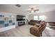 Spacious living room with comfortable leather sectional, large TV, and bright natural light at 3329 Brownes Creek Rd, Charlotte, NC 28269
