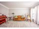 Comfortable living room with neutral carpeting, a vintage sofa, and an antique piano near a window at 3329 Brownes Creek Rd, Charlotte, NC 28269