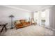 Cozy living room featuring plush carpeting, neutral walls, and natural light from the windows at 3329 Brownes Creek Rd, Charlotte, NC 28269