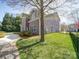 The home's backyard includes a grassy lawn, a stone walkway, and mature trees at 371 Montibello Dr, Mooresville, NC 28117