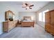 Bedroom featuring hardwood furniture, a ceiling fan, and neutral-toned carpet at 371 Montibello Dr, Mooresville, NC 28117