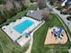 Aerial view of a community pool and playground, offering recreational amenities for residents at 371 Montibello Dr, Mooresville, NC 28117
