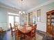 Dining room with hardwood floors, a stylish chandelier, and plenty of natural light at 371 Montibello Dr, Mooresville, NC 28117