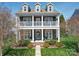 Charming two-story home boasts a welcoming front porch, detailed trim, and lush landscaping at 371 Montibello Dr, Mooresville, NC 28117