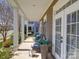 Inviting front porch featuring elegant columns, neutral tones, and outdoor seating at 371 Montibello Dr, Mooresville, NC 28117