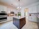 Bright kitchen features an island, stainless appliances, stone countertops, and ample cabinets at 371 Montibello Dr, Mooresville, NC 28117