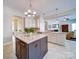 Bright, open kitchen featuring a large island, granite countertops, and modern stainless steel appliances at 371 Montibello Dr, Mooresville, NC 28117