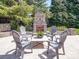Backyard offers a stone outdoor fireplace, seating, and is surrounded by mature landscaping at 371 Montibello Dr, Mooresville, NC 28117