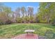 Beautiful, expansive backyard with mature trees and manicured lawn at 3716 Drayton Hall Ln, Charlotte, NC 28270