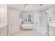 Bathroom with a clawfoot tub, tiled floor, and walk-in glass shower at 3716 Drayton Hall Ln, Charlotte, NC 28270