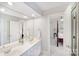 A bright bathroom with a double sink vanity offers a glimpse into an adjacent bedroom at 3716 Drayton Hall Ln, Charlotte, NC 28270