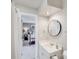 A bright bathroom with a white sink and vanity adjacent to a bedroom with a cozy bed at 3716 Drayton Hall Ln, Charlotte, NC 28270