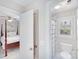This bathroom connects to a bedroom and features a shower tub combo with a white shower curtain at 3716 Drayton Hall Ln, Charlotte, NC 28270