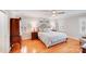 Bright bedroom with hardwood floors, a ceiling fan, two windows, and a large bed with pillows at 3716 Drayton Hall Ln, Charlotte, NC 28270