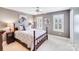 This bedroom boasts a cozy, carpeted floor, ceiling fan, and two windows with stylish shutters at 3716 Drayton Hall Ln, Charlotte, NC 28270
