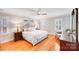 Primary bedroom with hardwood floors, a ceiling fan, and white walls at 3716 Drayton Hall Ln, Charlotte, NC 28270