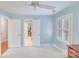 This blue bedroom with carpet features bright windows and white doors leading to other rooms at 3716 Drayton Hall Ln, Charlotte, NC 28270