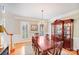 Formal dining room with hardwood floors, a chandelier, and elegant furnishings at 3716 Drayton Hall Ln, Charlotte, NC 28270