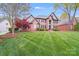 Stately brick home with a large front lawn and mature trees at 3716 Drayton Hall Ln, Charlotte, NC 28270