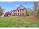 Elegant brick home with a well-manicured lawn and lush landscaping at 3716 Drayton Hall Ln, Charlotte, NC 28270
