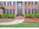 Inviting front entrance with manicured landscaping and classic brick facade at 3716 Drayton Hall Ln, Charlotte, NC 28270