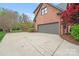 Attached two-car garage with a concrete driveway and brick exterior at 3716 Drayton Hall Ln, Charlotte, NC 28270