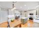 Bright kitchen with white cabinets, stainless steel appliances, center island, and hardwood floors, perfect for cooking at 3716 Drayton Hall Ln, Charlotte, NC 28270