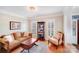 Cozy living room with a sofa, upholstered chair, and natural light at 3716 Drayton Hall Ln, Charlotte, NC 28270