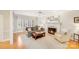 Bright living room with a fireplace, large windows, hardwood floors, and comfortable seating, creating a cozy space at 3716 Drayton Hall Ln, Charlotte, NC 28270